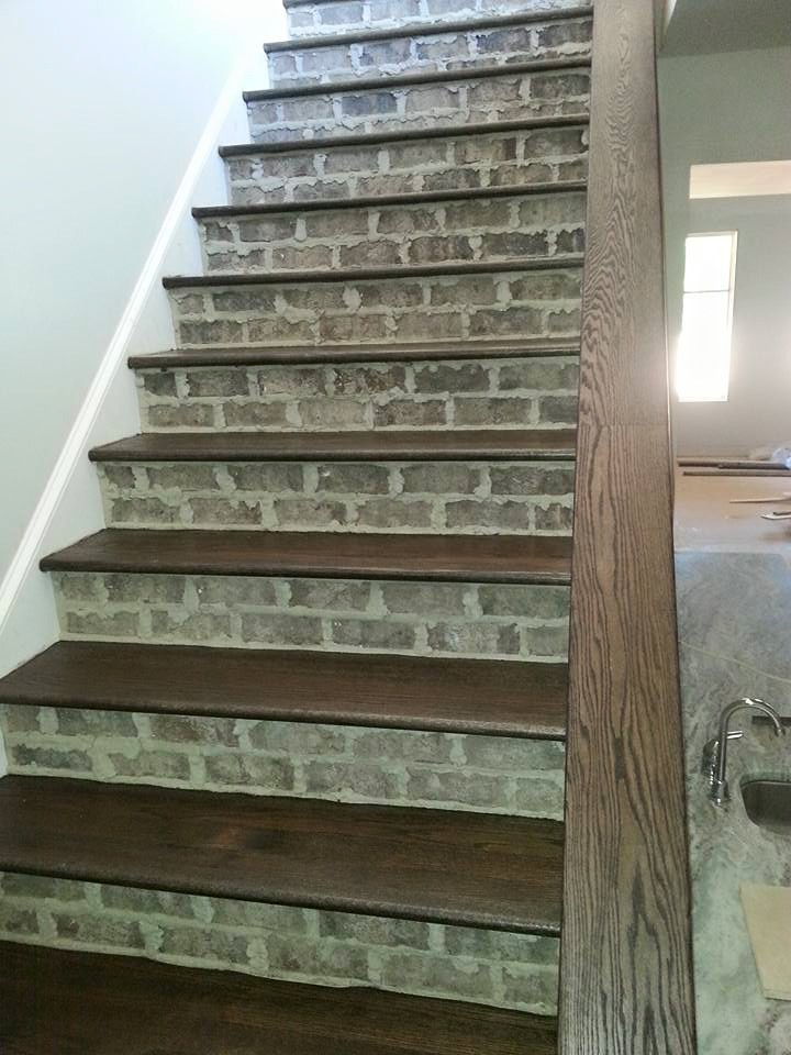 Wooden wood railing staircase photo with tile risers