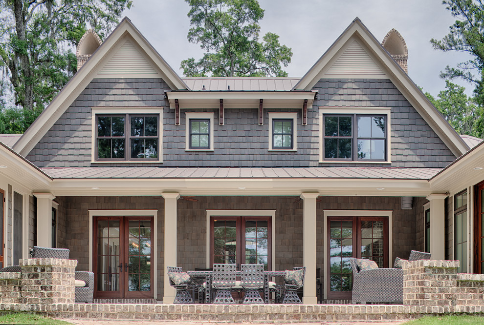 Inspiration for a large traditional two-storey grey exterior in Grand Rapids with wood siding and a gable roof.