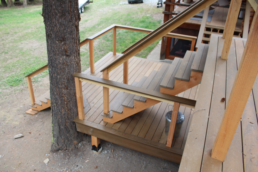 Inspiration for a large country backyard and first floor deck in Other with no cover and cable railing.