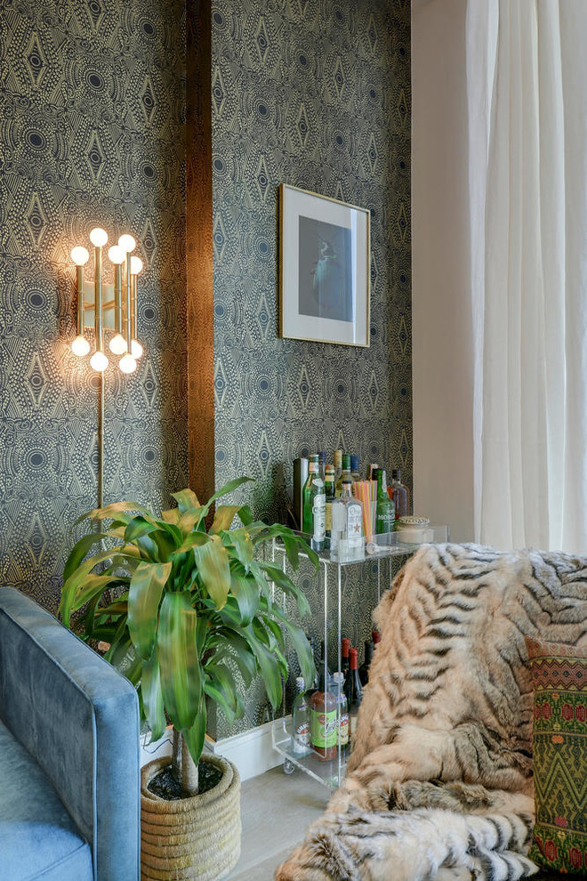 Small eclectic open concept medium tone wood floor living room photo in Other with black walls, no fireplace and a wall-mounted tv