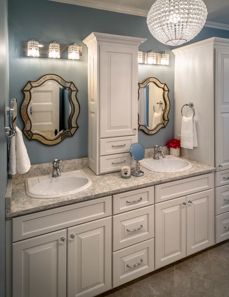 Photo of a large traditional kids bathroom in Other with raised-panel cabinets, white cabinets, a claw-foot tub, a double shower, a two-piece toilet, gray tile, porcelain tile, blue walls, porcelain floors, a drop-in sink, quartzite benchtops, grey floor, a sliding shower screen and grey benchtops.