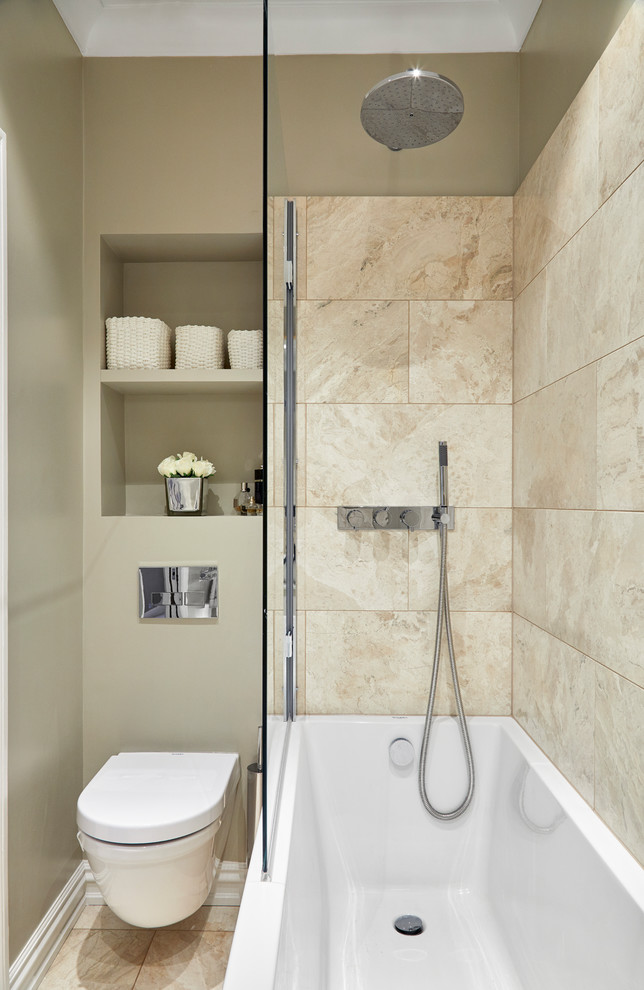 Inspiration for a small contemporary kids bathroom in London with flat-panel cabinets, beige cabinets, a drop-in tub, a shower/bathtub combo, a wall-mount toilet, beige tile, travertine, beige walls, limestone floors, a pedestal sink, solid surface benchtops, beige floor and an open shower.