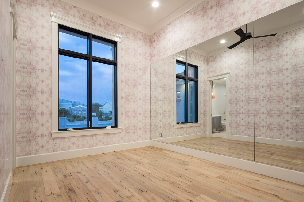 Inspiration for a large transitional multipurpose gym in Phoenix with pink walls, light hardwood floors and beige floor.
