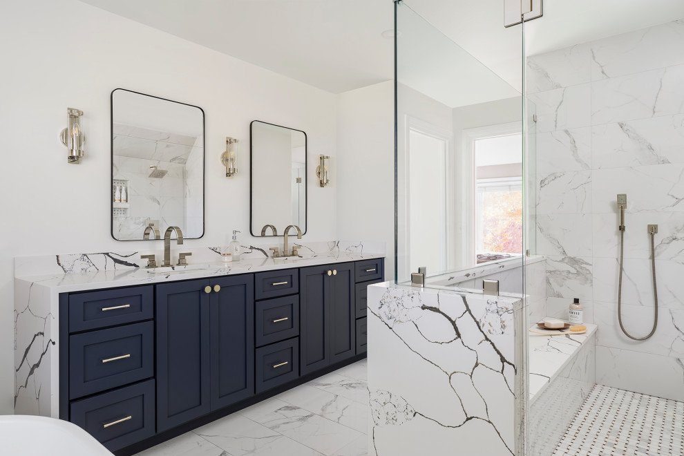 Large modern master bathroom in Minneapolis with recessed-panel cabinets, grey cabinets, a freestanding tub, a double shower, white tile, porcelain tile, white walls, porcelain floors, an undermount sink, engineered quartz benchtops, white floor, a hinged shower door, white benchtops, a shower seat, a double vanity and a built-in vanity.