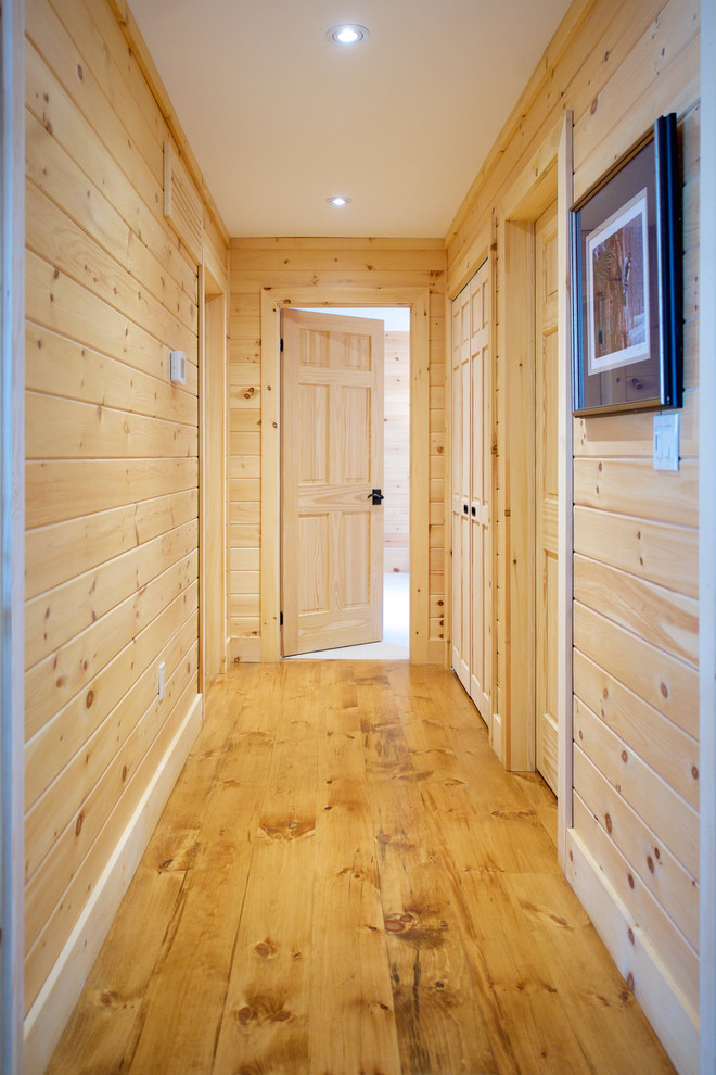 Design ideas for a mid-sized beach style hallway with medium hardwood floors.