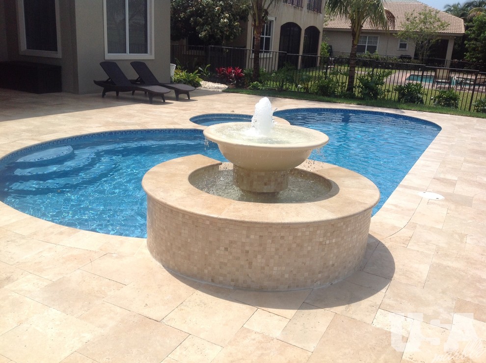 Pool - large rustic stone aboveground pool idea in Miami