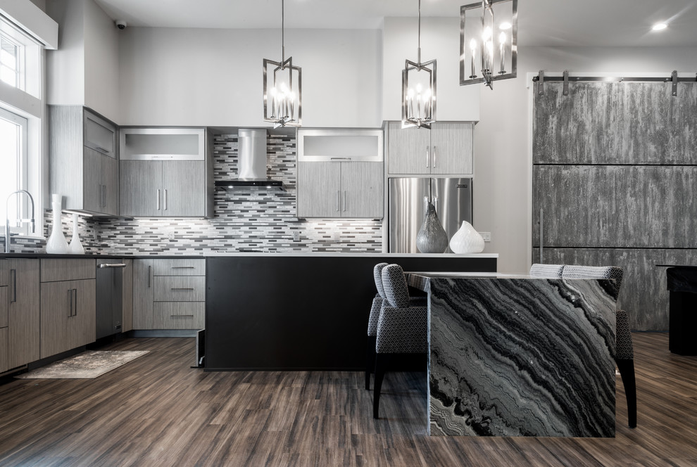Photo of a contemporary l-shaped open plan kitchen in Salt Lake City with an undermount sink, flat-panel cabinets, grey cabinets, matchstick tile splashback, stainless steel appliances and multiple islands.