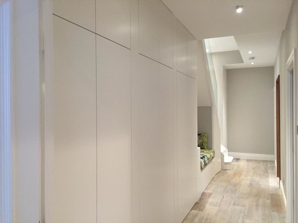 Design ideas for a mid-sized contemporary hallway in London with grey walls and light hardwood floors.