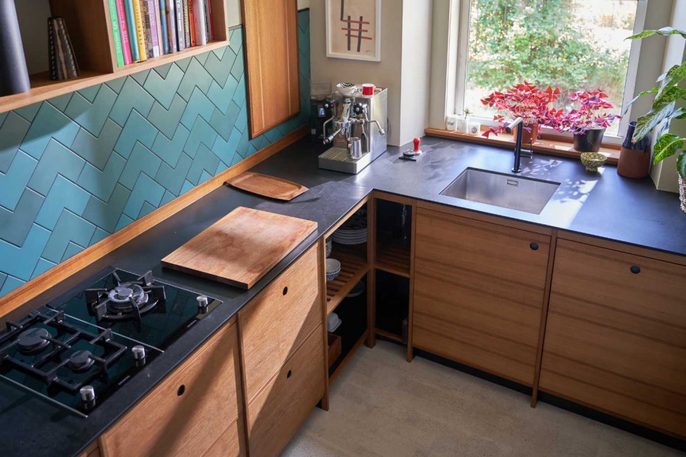 Design ideas for a mid-sized midcentury l-shaped separate kitchen in Edinburgh with a drop-in sink, flat-panel cabinets, black cabinets, wood benchtops, green splashback, cement tile splashback, cork floors, no island, white floor, black benchtop and coffered.