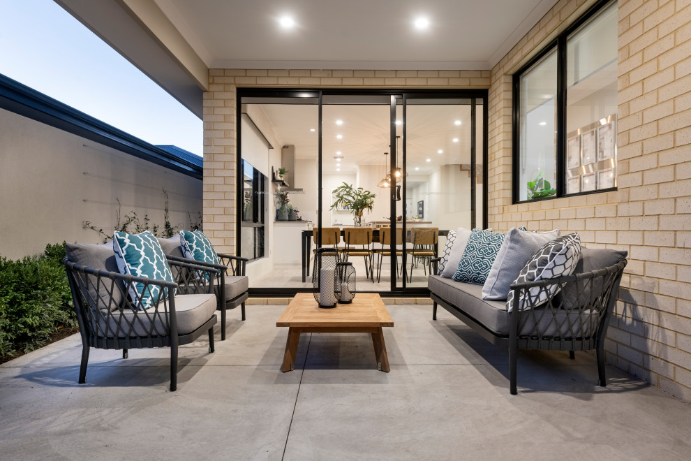 Photo of a mid-sized contemporary backyard patio in Perth with concrete slab and a roof extension.