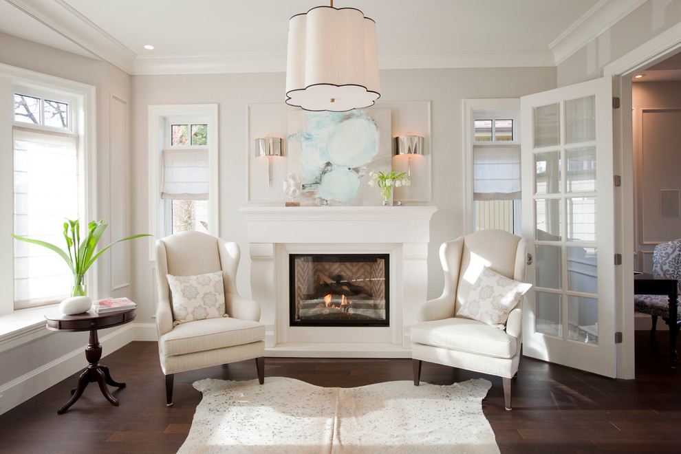 Photo of a transitional living room in Vancouver with a standard fireplace and beige walls.