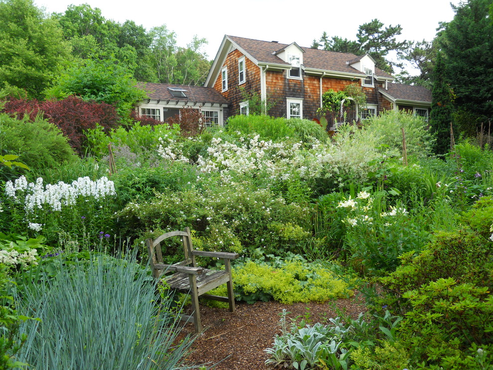Photo of a large traditional backyard partial sun formal garden in Providence with mulch and a garden path.