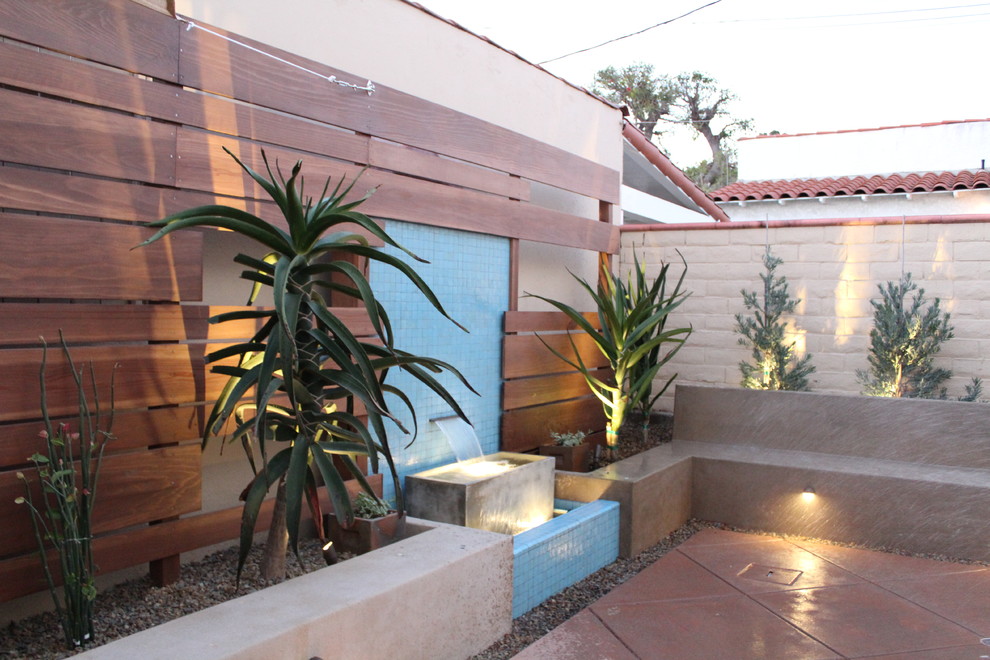 This is an example of a small mediterranean backyard full sun xeriscape in Los Angeles.