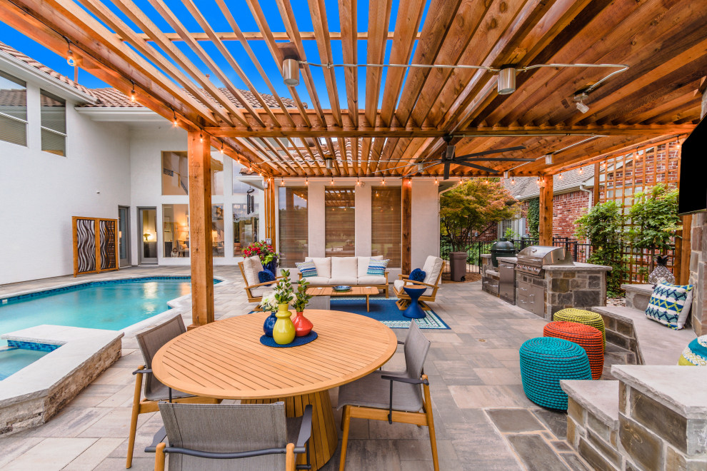 Photo of a large transitional backyard patio in Dallas with with fireplace, concrete pavers and a pergola.