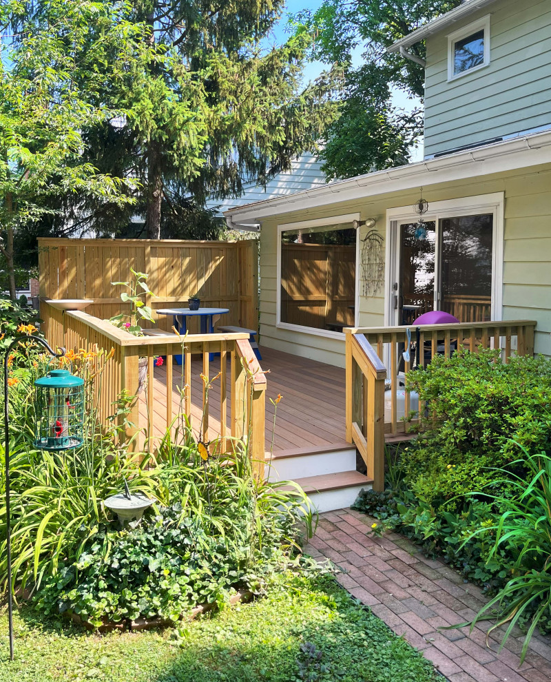 Inspiration for a mid-sized transitional backyard and ground level deck in Philadelphia with wood railing.