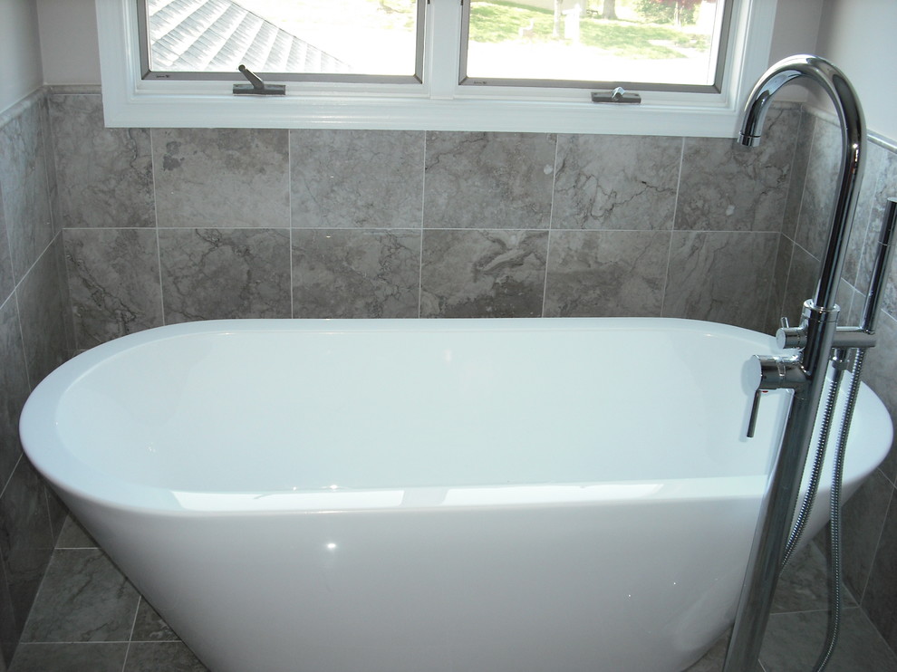 Freestanding bathtub - large transitional master black and white tile and porcelain tile ceramic tile freestanding bathtub idea in Baltimore with shaker cabinets, dark wood cabinets, a one-piece toilet, gray walls, a vessel sink and granite countertops