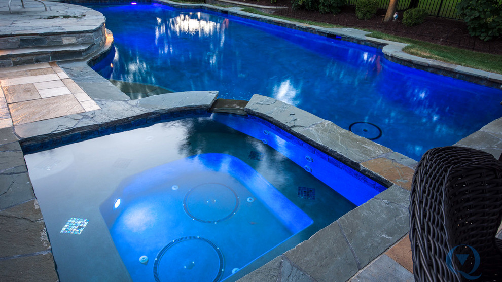 Inspiration for a mid-sized rustic backyard stone and custom-shaped lap pool remodel in Chicago
