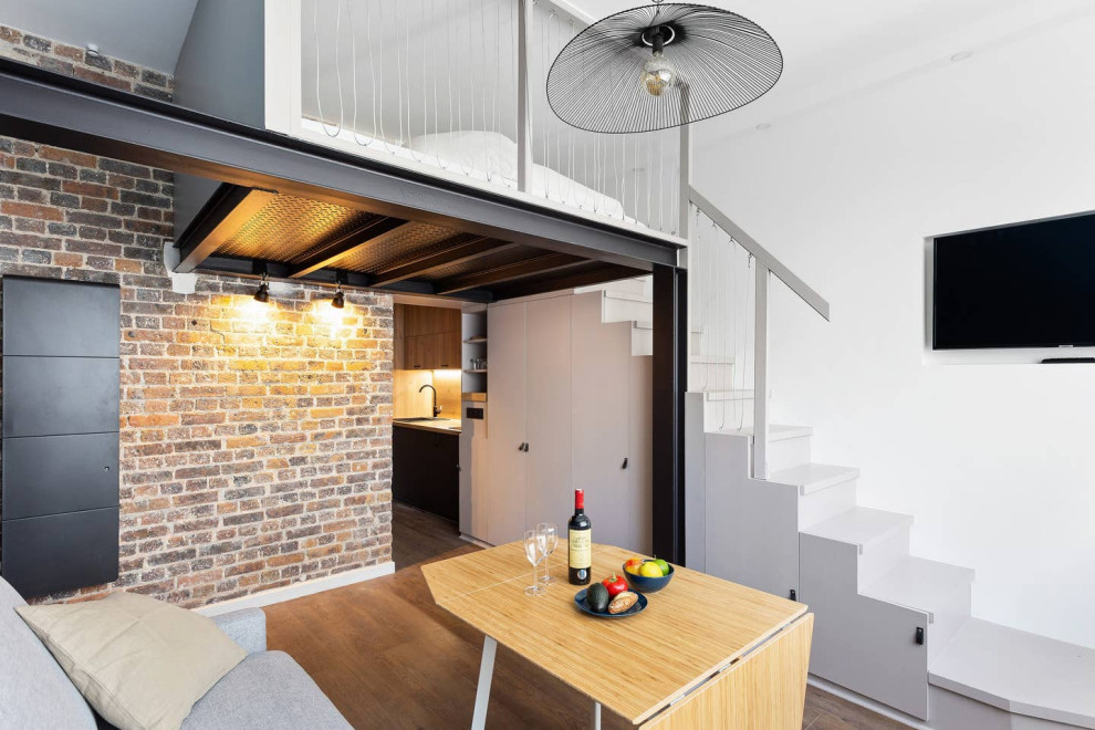 Imagen de salón tipo loft urbano pequeño sin chimenea con paredes blancas, suelo de contrachapado y pared multimedia