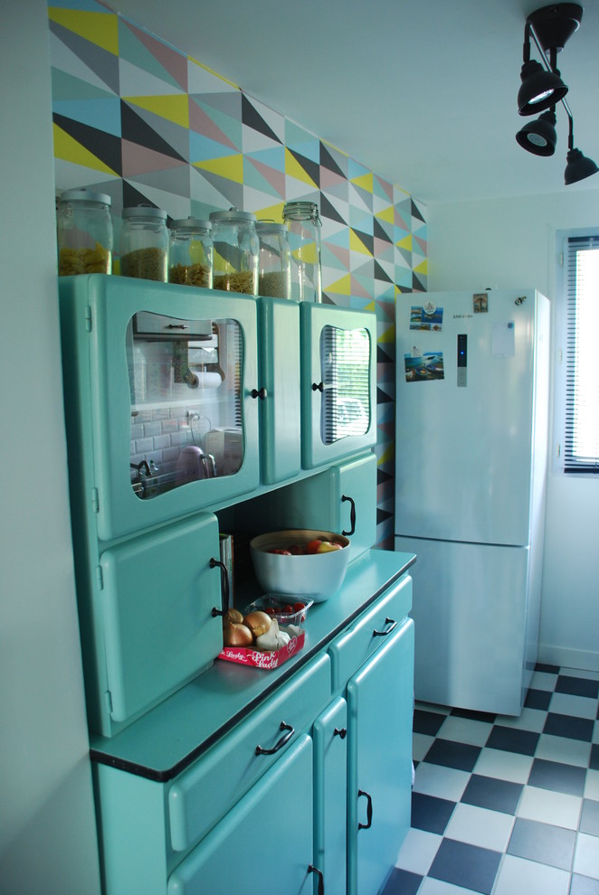 Small midcentury galley separate kitchen in Paris with a double-bowl sink, raised-panel cabinets, green cabinets, laminate benchtops, white splashback, subway tile splashback, black appliances, ceramic floors and no island.