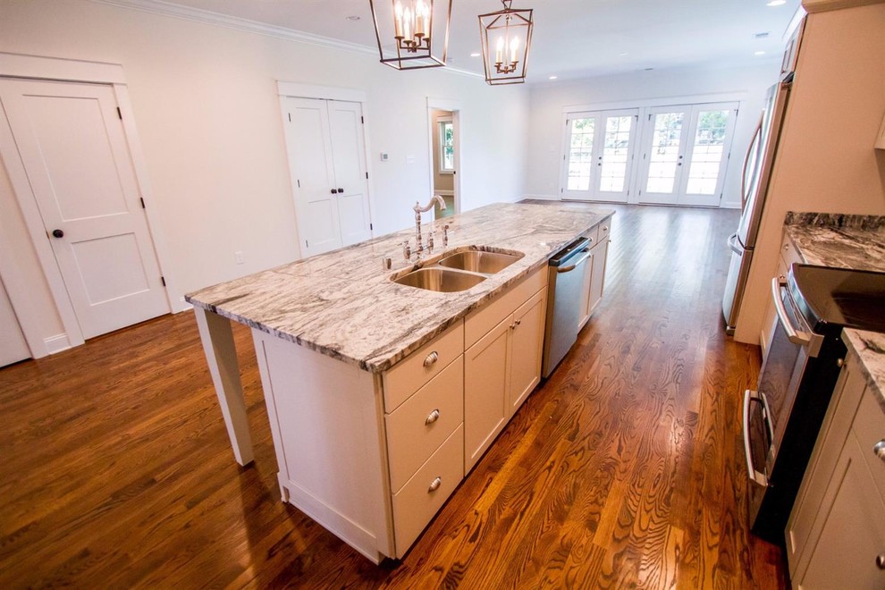 Inspiration for a large transitional single-wall dark wood floor and brown floor enclosed kitchen remodel with an undermount sink, shaker cabinets, gray cabinets, marble countertops, stainless steel appliances and an island