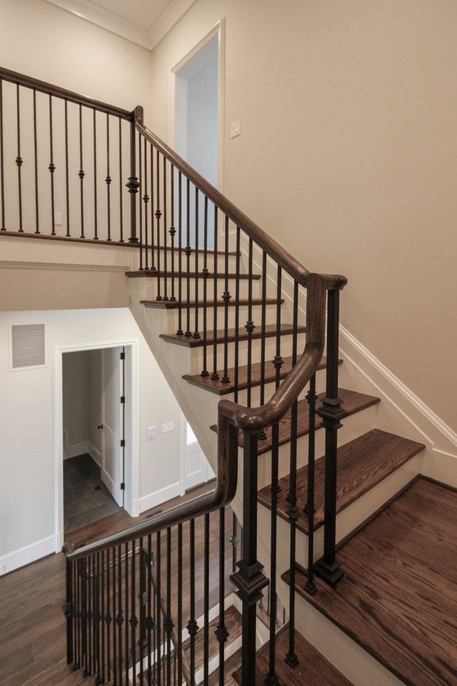 Inspiration for a large timeless wooden floating metal railing staircase remodel in DC Metro with painted risers
