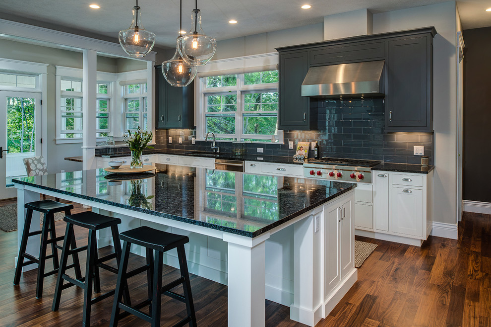 Inspiration for a large transitional l-shaped dark wood floor and brown floor open concept kitchen remodel with an undermount sink, shaker cabinets, gray cabinets, quartz countertops, gray backsplash, glass tile backsplash, stainless steel appliances and an island