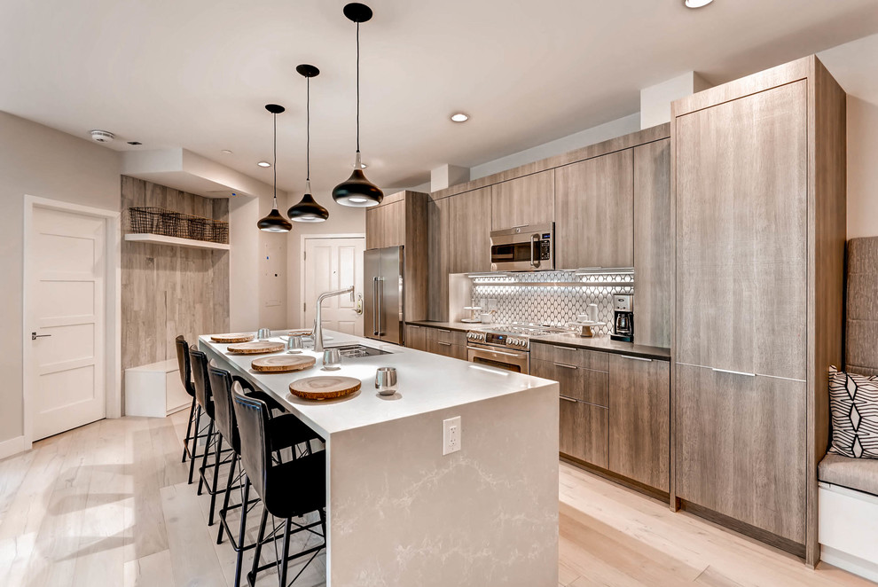 Design ideas for a large contemporary eat-in kitchen in Denver with an undermount sink, flat-panel cabinets, light wood cabinets, onyx benchtops, white splashback, porcelain splashback, stainless steel appliances, porcelain floors, with island and grey floor.