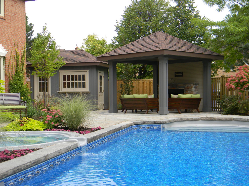 Example of a mid-sized transitional backyard concrete paver and rectangular pool house design in Toronto