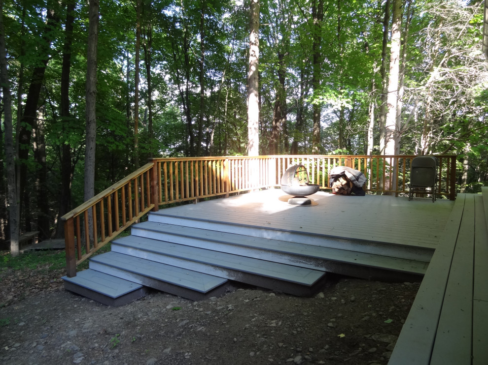 Deck - mid-sized traditional backyard ground level wood railing deck idea in New York with a fireplace and no cover