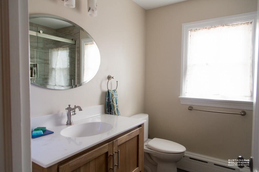 Bathroom - transitional single-sink bathroom idea with light wood cabinets