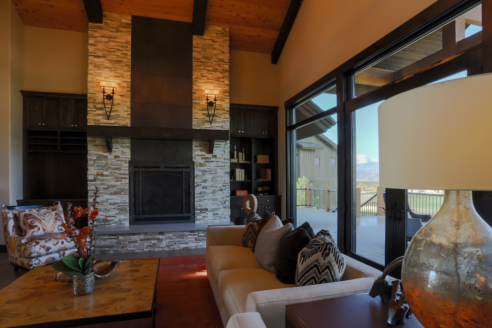 Photo of a large transitional formal open concept living room in Orange County with beige walls, dark hardwood floors, a standard fireplace, a stone fireplace surround and no tv.