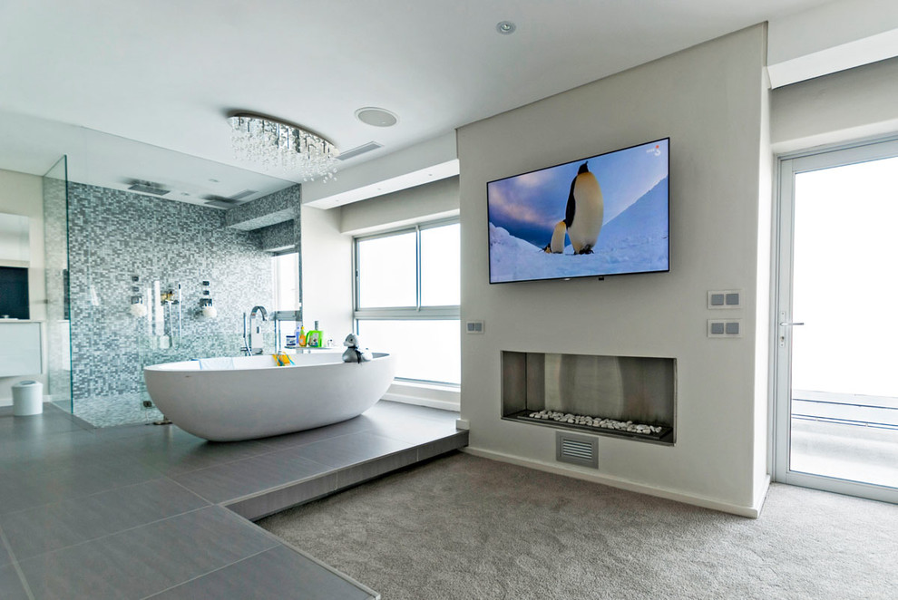 Large modern master bedroom in Other with white walls, carpet and a ribbon fireplace.
