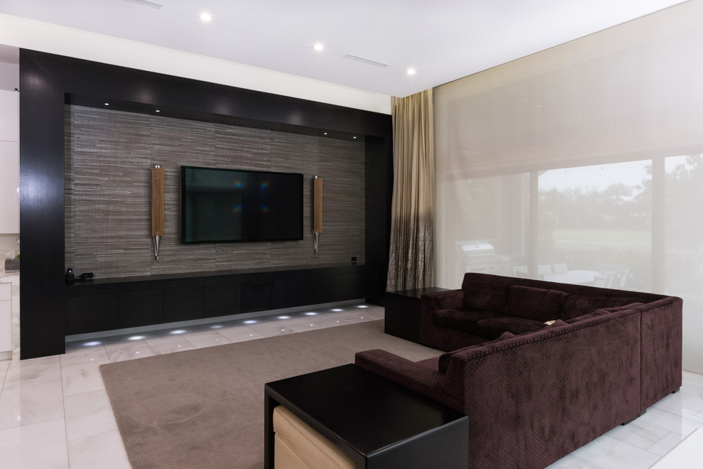 This is an example of a large modern open concept home theatre in Miami with grey walls, marble floors, a wall-mounted tv and grey floor.