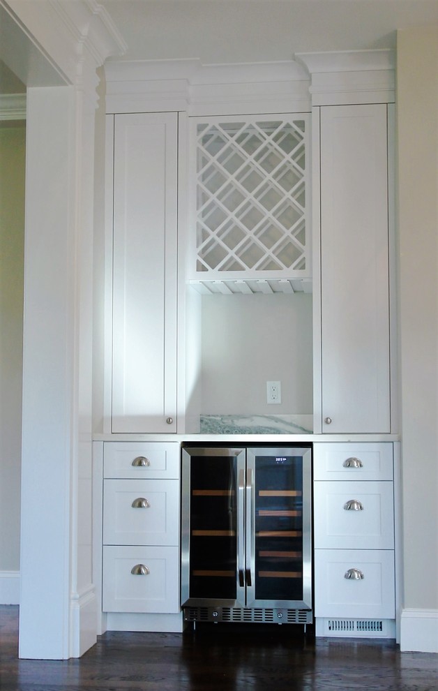 Inspiration for a mid-sized transitional u-shaped dark wood floor and brown floor eat-in kitchen remodel in Boston with an undermount sink, shaker cabinets, white cabinets, marble countertops, white backsplash, porcelain backsplash, stainless steel appliances and an island