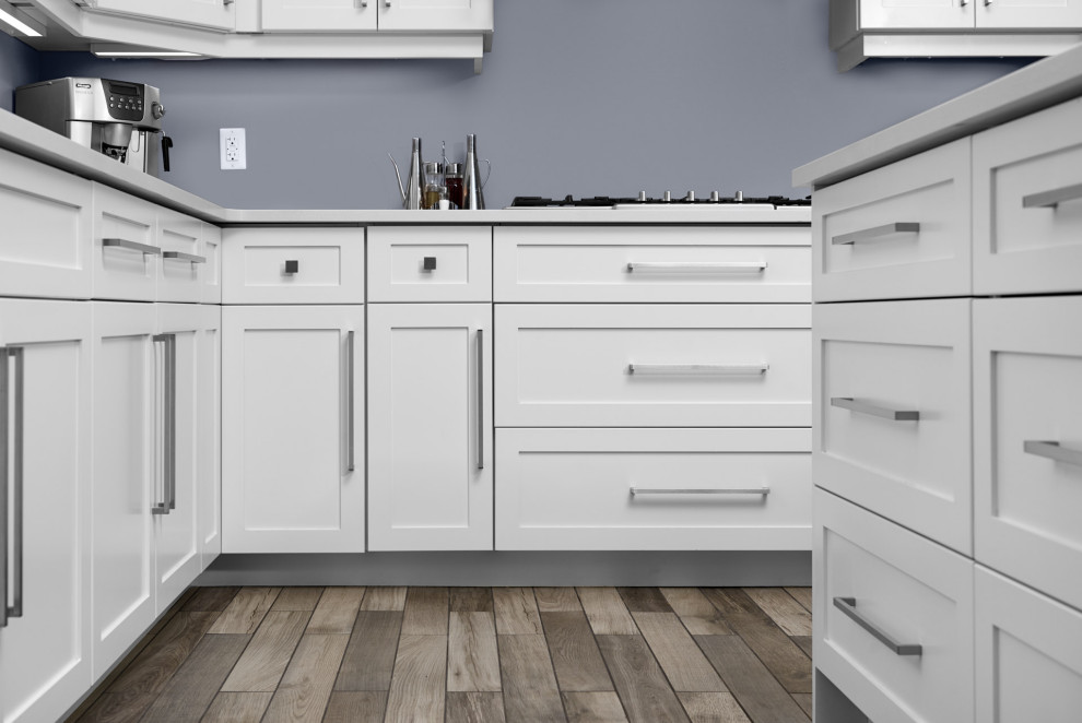 Inspiration for a transitional l-shaped ceramic tile and gray floor enclosed kitchen remodel in Toronto with an undermount sink, shaker cabinets, white cabinets, quartzite countertops, stainless steel appliances, an island and white countertops
