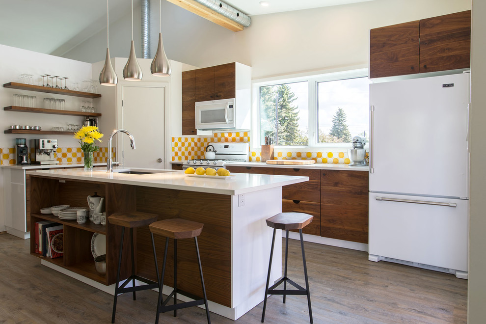 This is an example of a small contemporary l-shaped eat-in kitchen in Edmonton with an undermount sink, flat-panel cabinets, dark wood cabinets, quartzite benchtops, yellow splashback, white appliances, vinyl floors and with island.