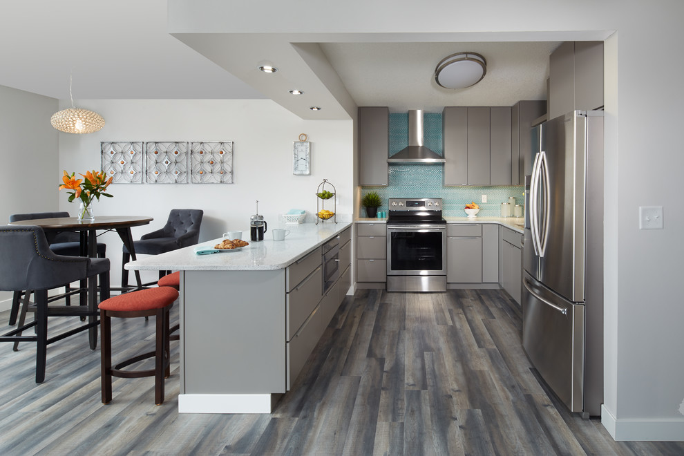 Inspiration for a small contemporary u-shaped dark wood floor eat-in kitchen remodel in Atlanta with an undermount sink, shaker cabinets, gray cabinets, blue backsplash, stainless steel appliances and an island
