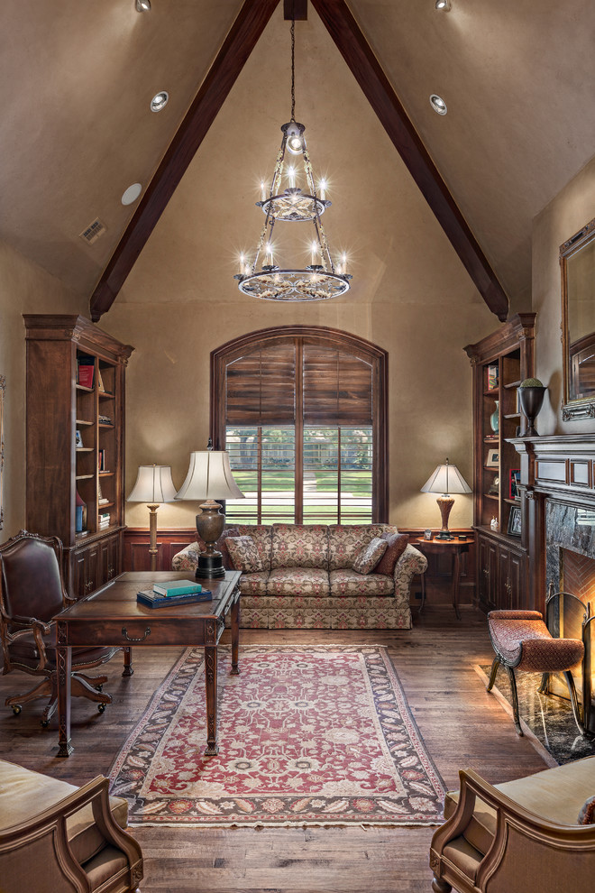 This is an example of a large traditional study room in Dallas with beige walls, dark hardwood floors, a freestanding desk, a standard fireplace and a stone fireplace surround.