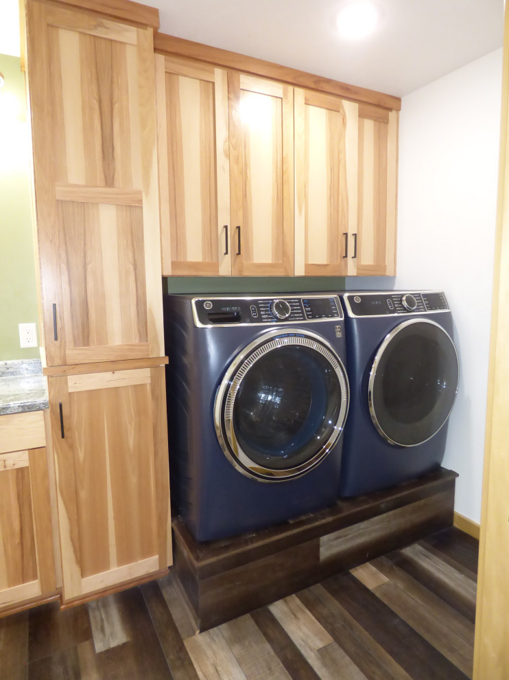 Mid-sized contemporary single-wall utility room in Other with flat-panel cabinets, light wood cabinets, laminate benchtops, white walls, vinyl floors, a side-by-side washer and dryer, multi-coloured floor and grey benchtop.