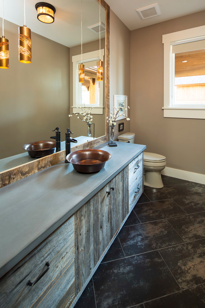 Design ideas for a mid-sized country 3/4 bathroom in Minneapolis with flat-panel cabinets, distressed cabinets, a two-piece toilet, beige walls, a vessel sink, concrete benchtops and slate floors.