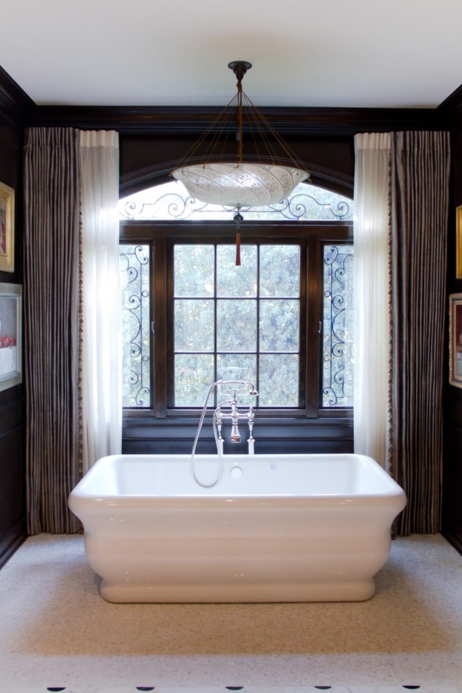 Inspiration for a traditional master bathroom in Los Angeles with a freestanding tub, black walls and mosaic tile floors.