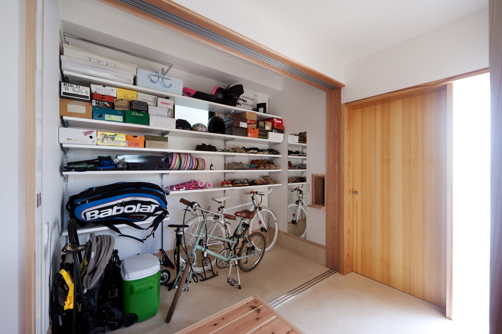 Design ideas for a contemporary storage and wardrobe in Other with concrete floors.