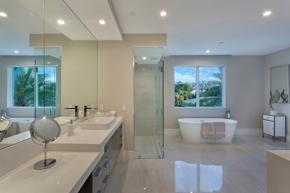 This is an example of a mid-sized contemporary master bathroom in Other with flat-panel cabinets, dark wood cabinets, a corner shower, a one-piece toilet, beige tile, marble, beige walls, marble floors, a drop-in sink, solid surface benchtops, beige floor, an open shower and white benchtops.