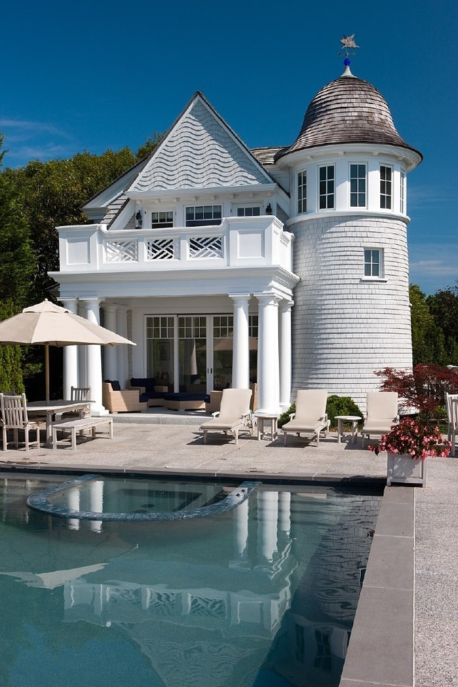 This is an example of a traditional rectangular pool in Boston with decomposed granite and a pool house.