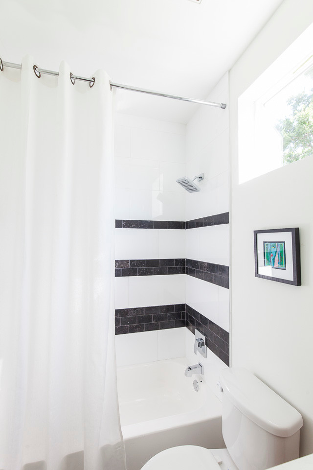 Inspiration for a small transitional 3/4 bathroom in Austin with flat-panel cabinets, white cabinets, a two-piece toilet, black and white tile, ceramic tile, white walls, ceramic floors, a drop-in sink and engineered quartz benchtops.