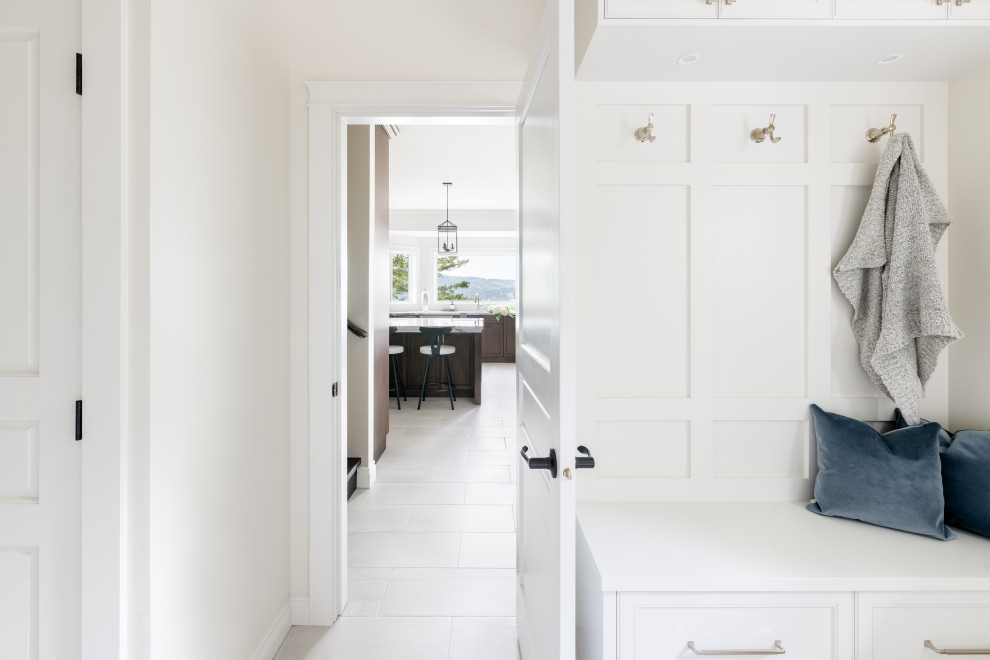 Mudroom - mid-sized transitional porcelain tile and white floor mudroom idea in Vancouver with white walls and a white front door