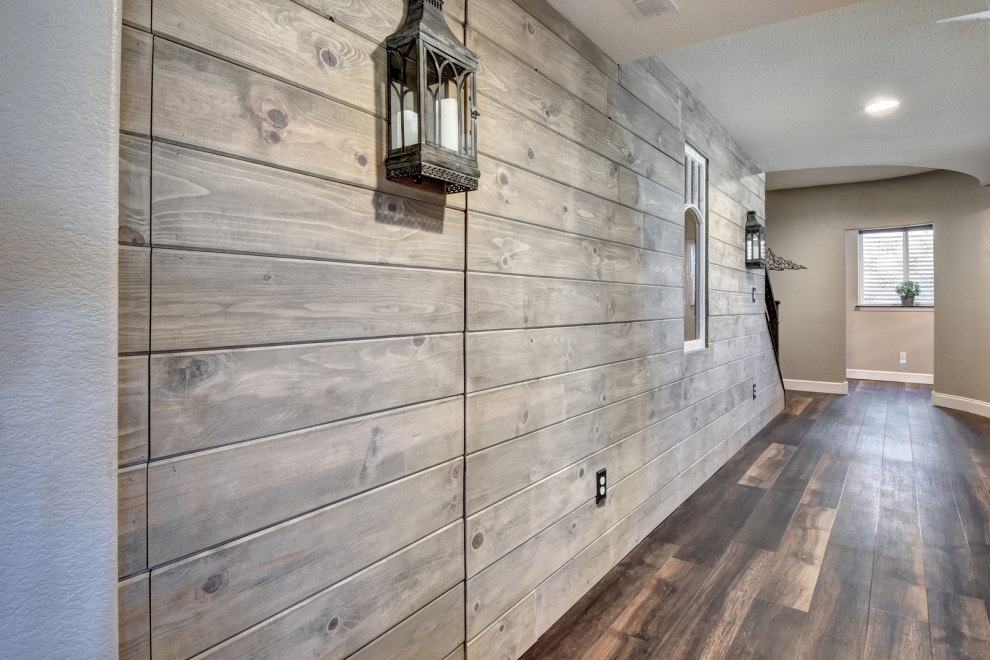 This is an example of a large industrial look-out basement in Denver with grey walls, vinyl floors and brown floor.