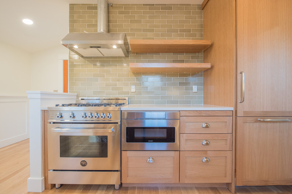 Small transitional galley light wood floor and beige floor enclosed kitchen photo in Portland with a farmhouse sink, shaker cabinets, light wood cabinets, quartz countertops, green backsplash, subway tile backsplash, paneled appliances, no island and white countertops