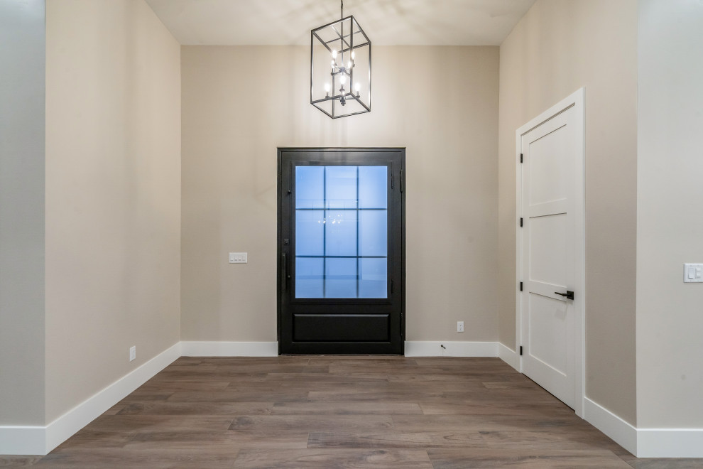 Inspiration for a large modern ceramic tile front door remodel in Phoenix with a black front door