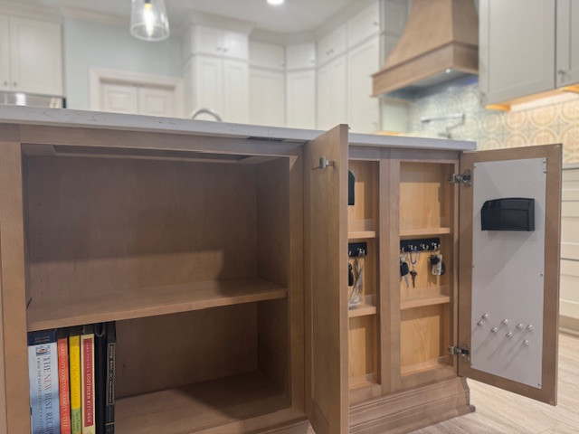 Mid-sized transitional l-shaped eat-in kitchen photo with an undermount sink, recessed-panel cabinets, beige cabinets, quartz countertops, porcelain backsplash, stainless steel appliances, an island and white countertops